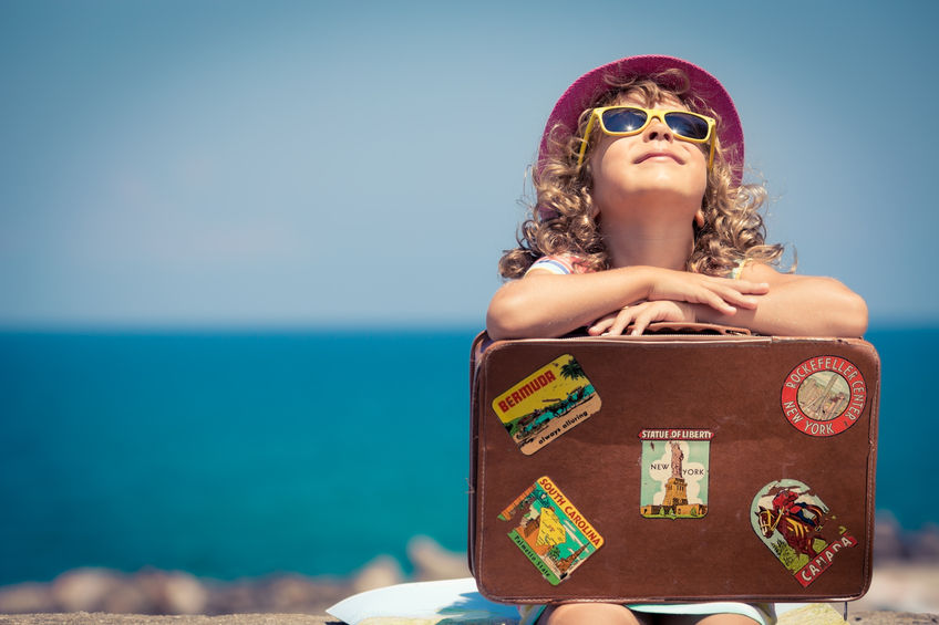 38259947 - child with vintage suitcase on summer vacation. travel and adventure concept